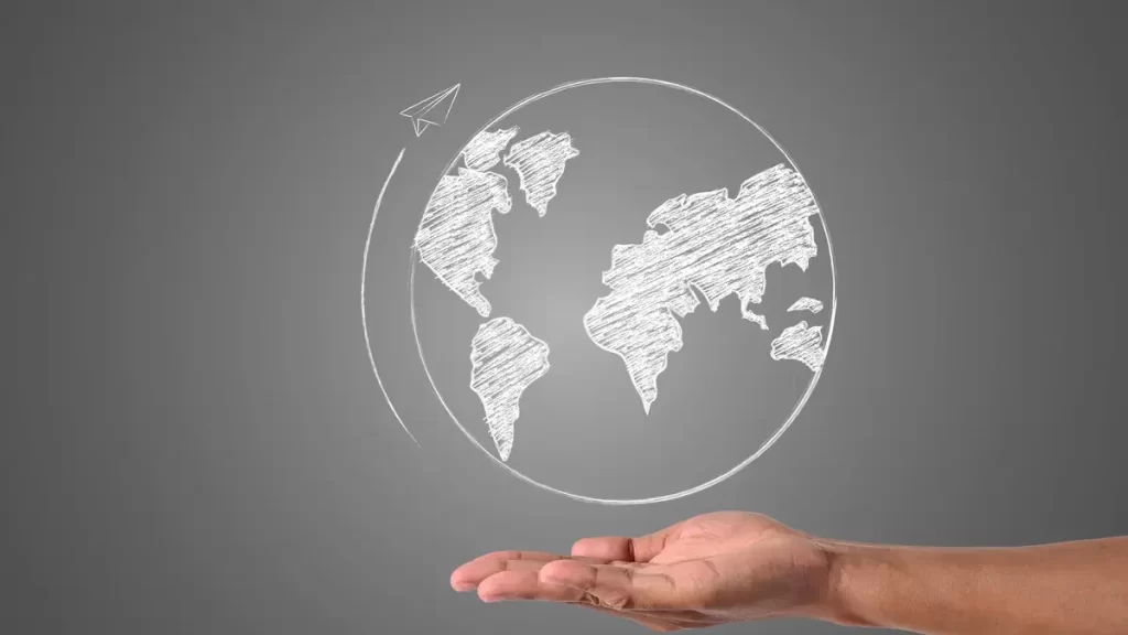 comunicação internacional Comunicação internacional. Mundo desenhado na palma da mão de um homem branco.